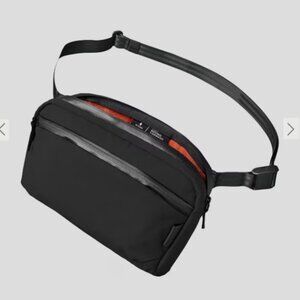 NWOT ALPAKA Flight Sling Crossbody Bag Travel Lightweight 2L Black/Orange